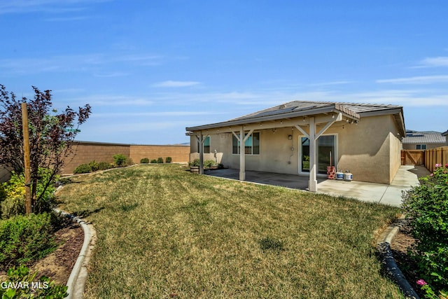 3932 Birchwood Ave, Rosamond, CA 93560 - back of property featuring stucco siding, a fenced backyard, and a patio area