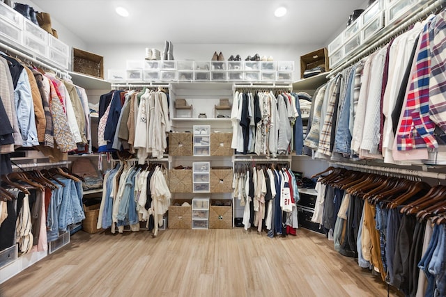 walk in closet with wood finished floors