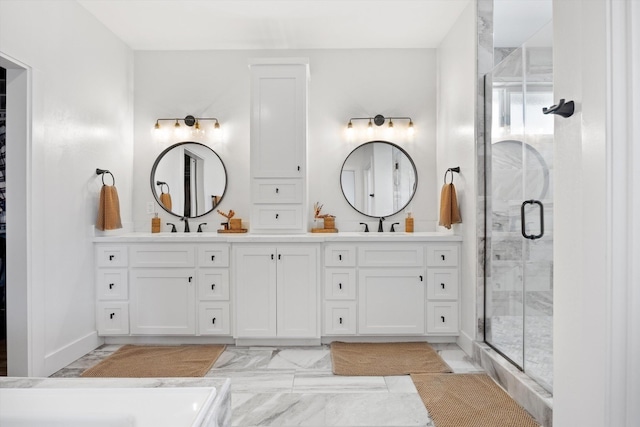 full bath featuring a sink, marble finish floor, a stall shower, and double vanity