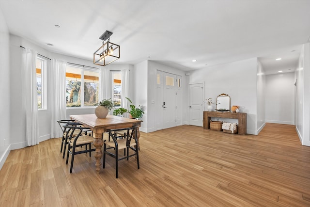 dining area featuring recessed lighting, baseboards, and light wood finished floors