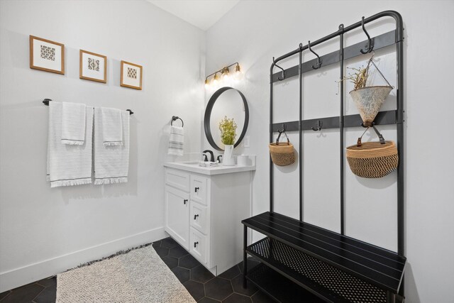 bathroom with tile patterned floors, vanity, and baseboards