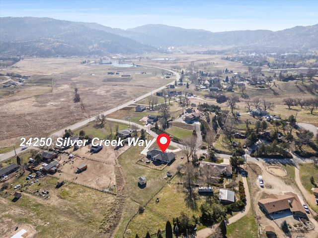 birds eye view of property featuring a mountain view