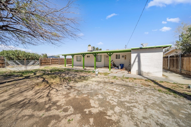 15872 Rexroth St, Mojave, CA 93501 - back of property featuring a fenced backyard, a patio, and a chimney