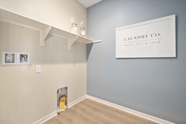 clothes washing area with laundry area, washer hookup, baseboards, and wood finished floors
