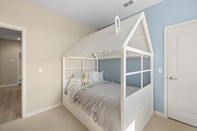 bedroom with carpet, visible vents, and baseboards