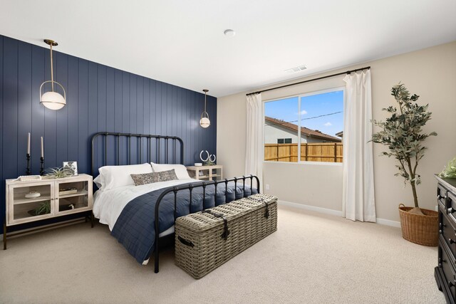 carpeted bedroom with visible vents and baseboards