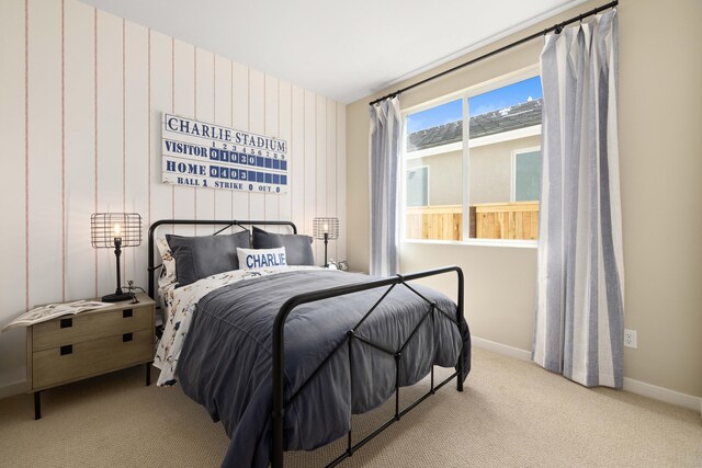 bedroom featuring carpet and baseboards