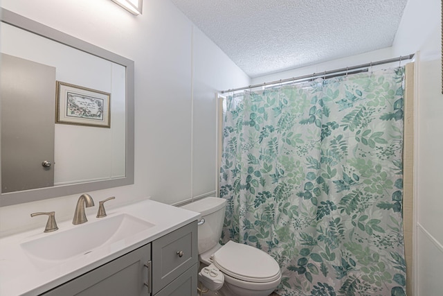 bathroom featuring vanity, a shower with shower curtain, a textured ceiling, and toilet