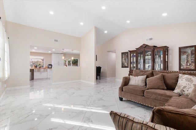 living room with high vaulted ceiling