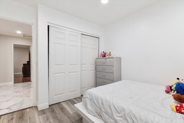 bedroom featuring a closet and light hardwood / wood-style floors