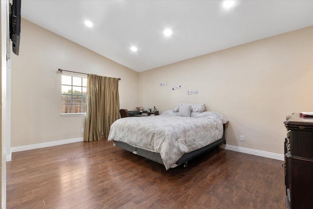 bedroom with lofted ceiling and dark wood-type flooring