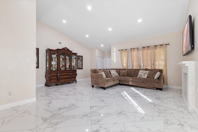 living room with a fireplace and vaulted ceiling