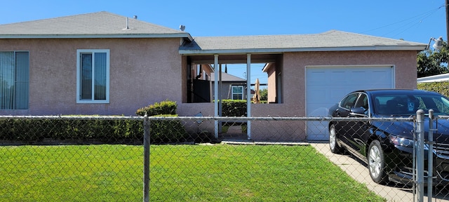 view of side of home with stucco siding, a lawn, a garage, and fence