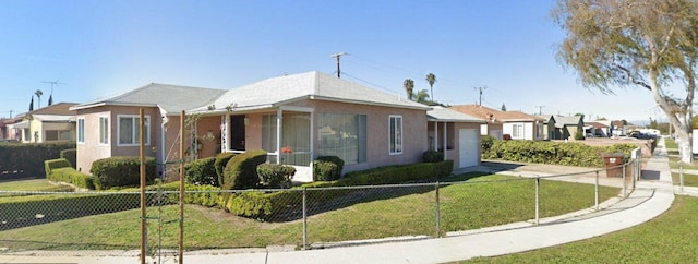 bungalow-style house with a fenced front yard, driveway, and a front yard