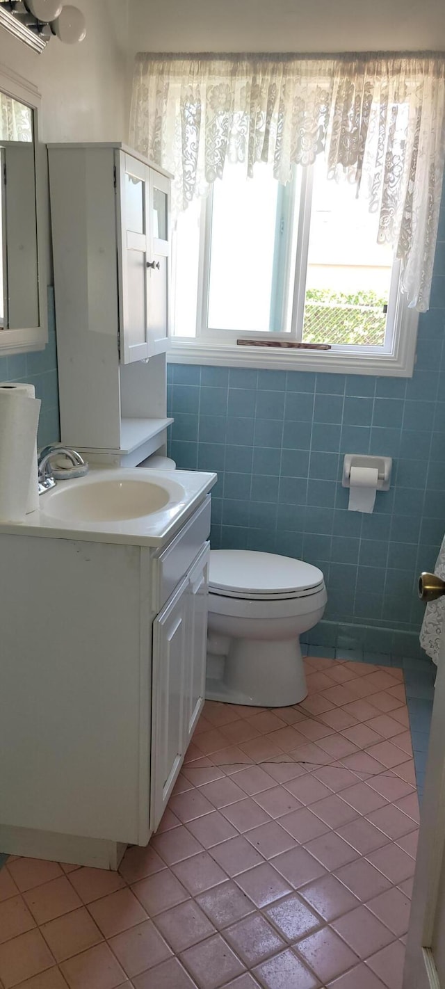 1103 W Bennett St, Compton, CA 90220 - half bath featuring tile patterned flooring, toilet, plenty of natural light, and vanity