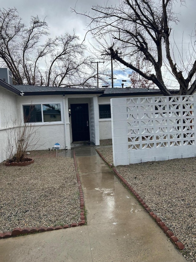 doorway to property featuring stucco siding