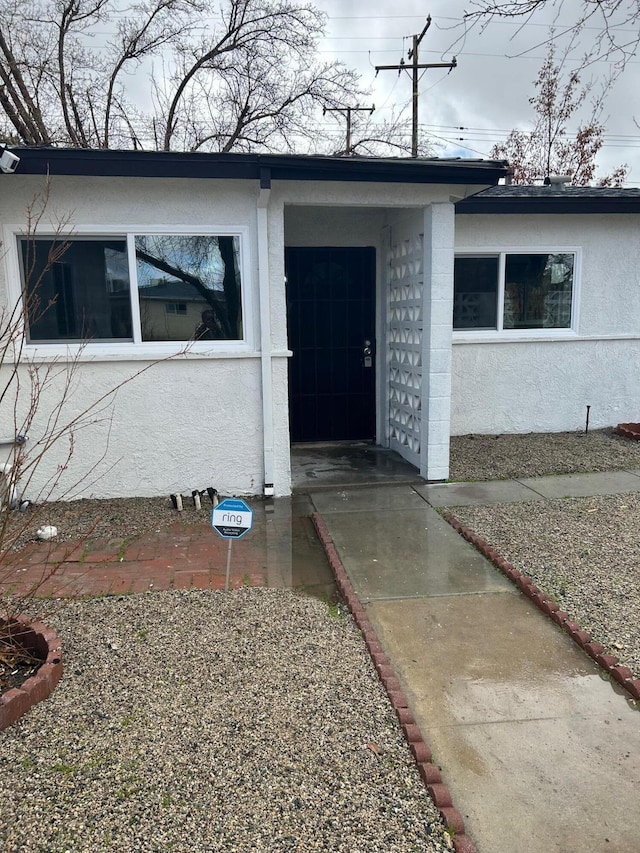 property entrance with stucco siding