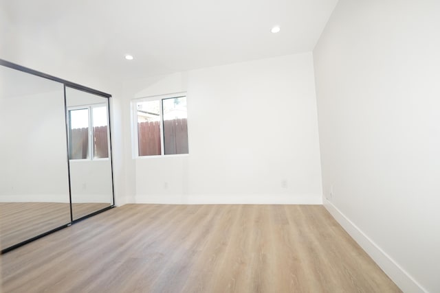 unfurnished bedroom with light hardwood / wood-style floors and a closet