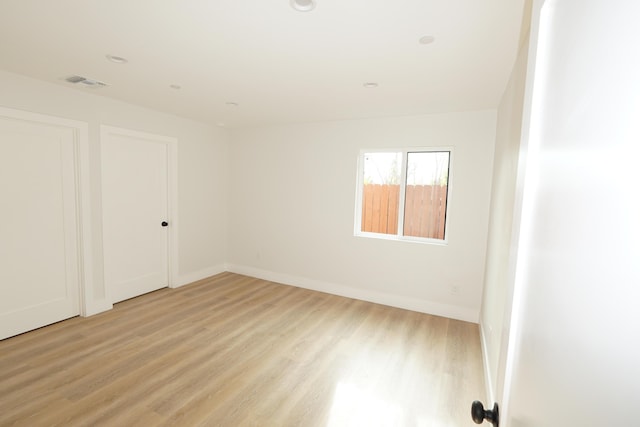 unfurnished room with light hardwood / wood-style flooring