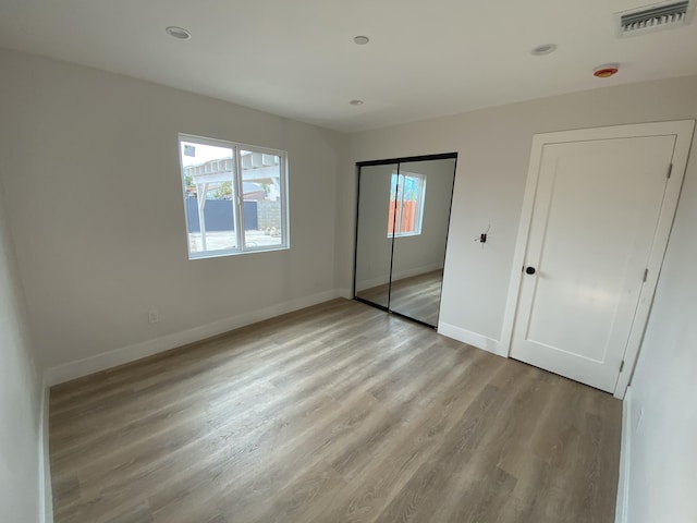 unfurnished bedroom featuring light wood-type flooring