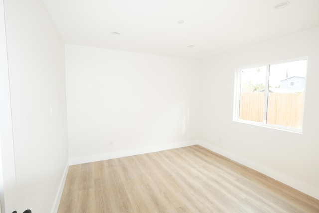 empty room with light hardwood / wood-style flooring