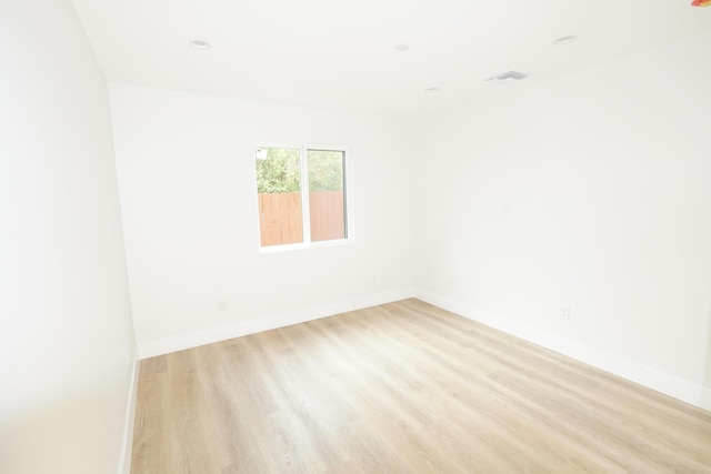 unfurnished room with light hardwood / wood-style floors