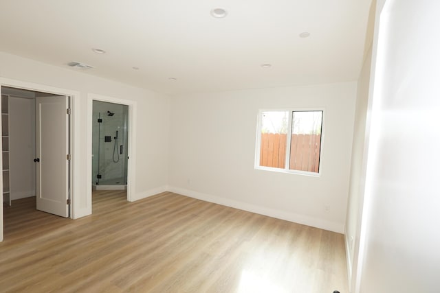 unfurnished bedroom featuring a closet and light hardwood / wood-style flooring