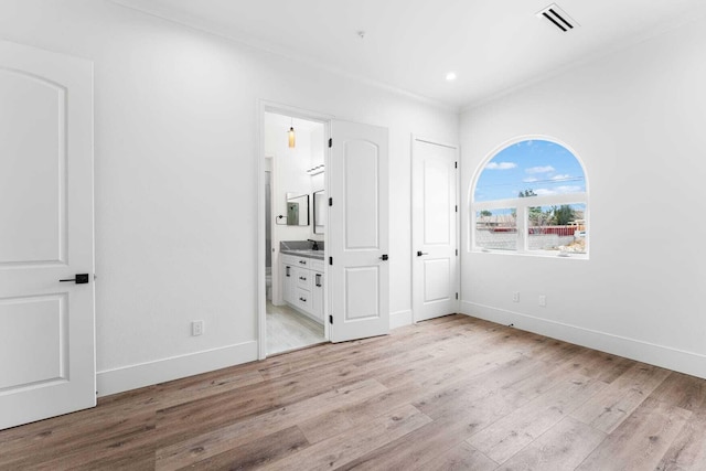 42730 W 23rd St, Lancaster, CA 93536 - unfurnished bedroom featuring ensuite bathroom, sink, and light wood-type flooring