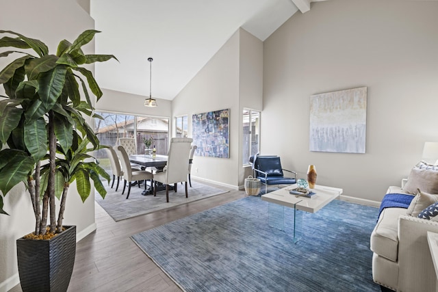 living room featuring hardwood / wood-style floors, high vaulted ceiling, and beamed ceiling