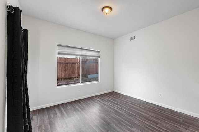 empty room featuring dark hardwood / wood-style flooring