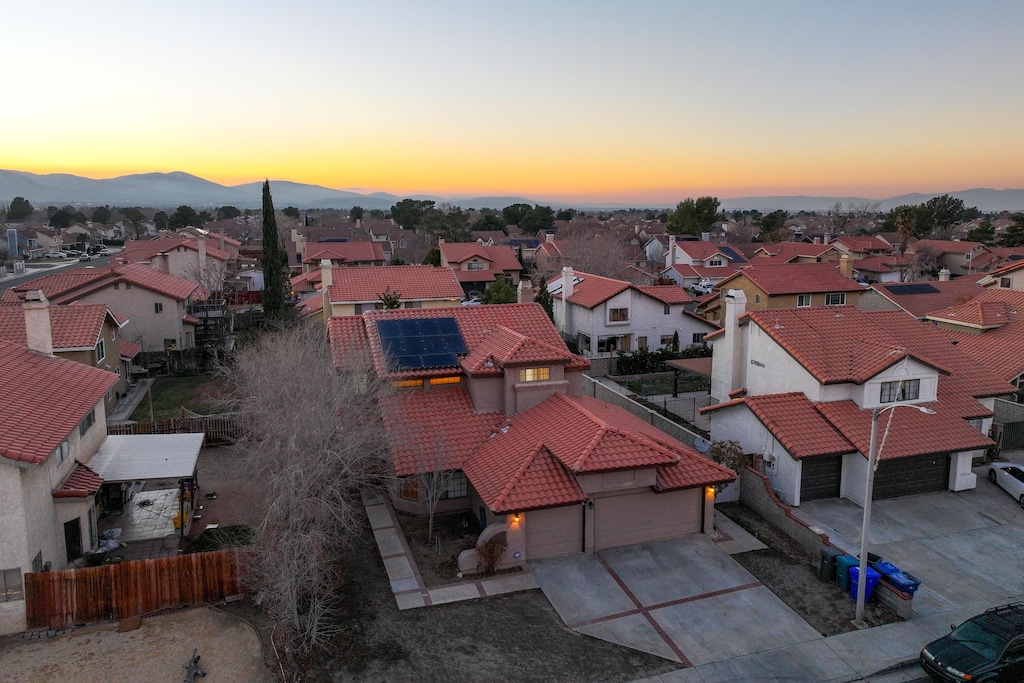 aerial view at dusk featuring a mountain view