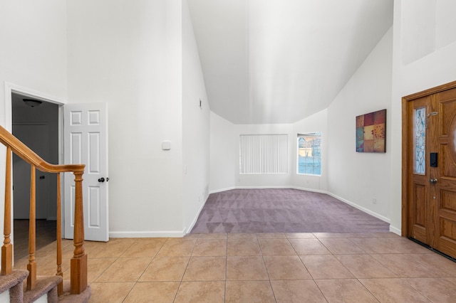 tiled entryway with high vaulted ceiling