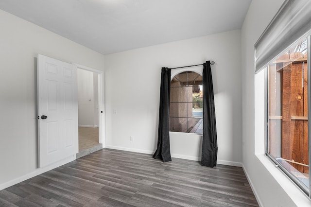 unfurnished room with dark hardwood / wood-style floors