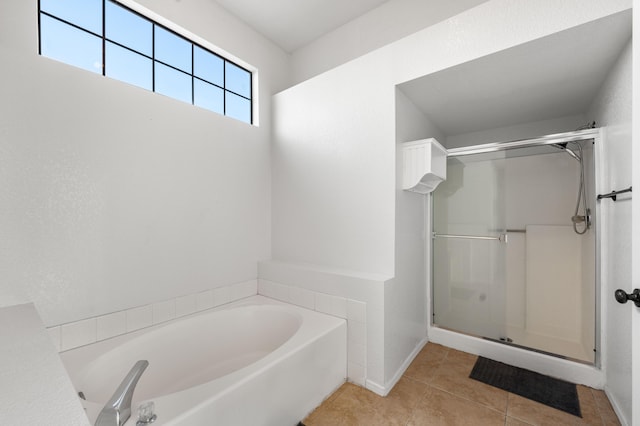 bathroom featuring tile patterned flooring and plus walk in shower