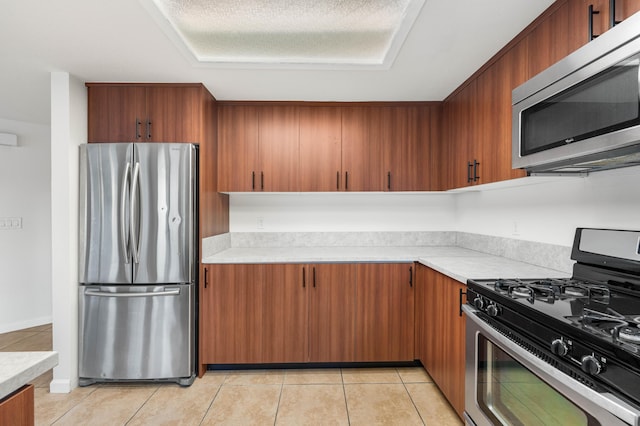 kitchen with light tile patterned floors and stainless steel appliances