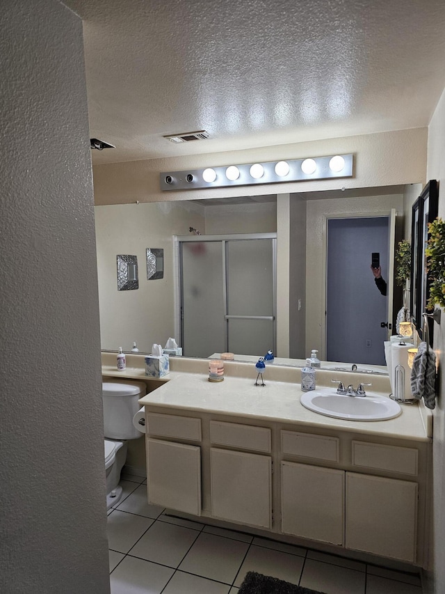 403 Sunrise Ter, Palmdale, CA 93551 - bathroom with a textured wall, tile patterned flooring, toilet, a textured ceiling, and a stall shower
