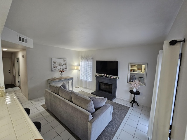 403 Sunrise Ter, Palmdale, CA 93551 - living area featuring a brick fireplace, light tile patterned flooring, and visible vents