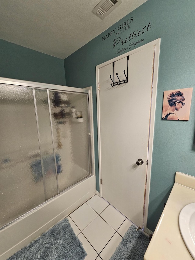 403 Sunrise Ter, Palmdale, CA 93551 - full bathroom with tile patterned floors, visible vents, combined bath / shower with glass door, and vanity