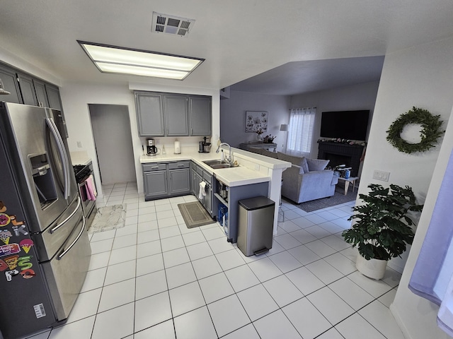 403 Sunrise Ter, Palmdale, CA 93551 - kitchen with visible vents, a peninsula, stainless steel fridge with ice dispenser, a sink, and gray cabinetry