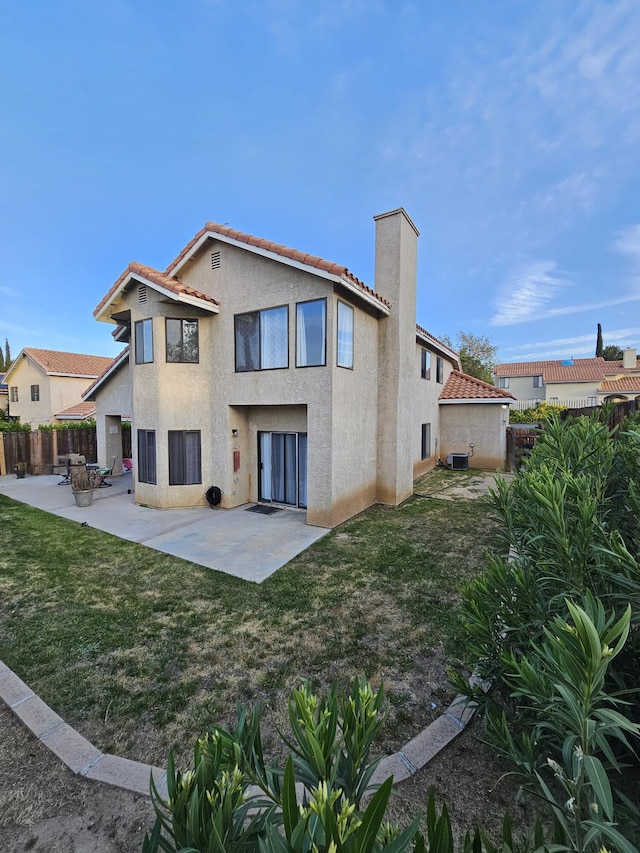 403 Sunrise Ter, Palmdale, CA 93551 - rear view of property featuring fence, stucco siding, a chimney, a patio area, and a tiled roof