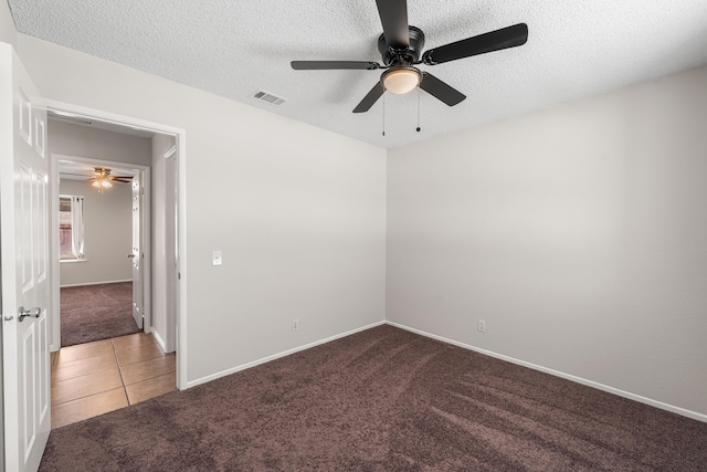 38115 E 41st St, Palmdale, CA 93552 - tiled spare room featuring carpet flooring, a ceiling fan, a textured ceiling, and baseboards