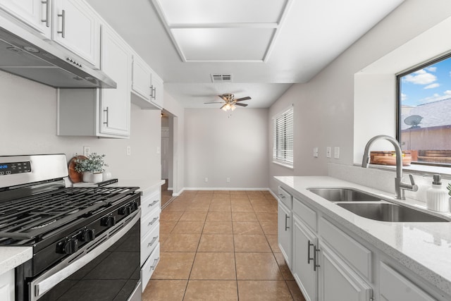 38115 E 41st St, Palmdale, CA 93552 - kitchen featuring gas stove, under cabinet range hood, a sink, white cabinets, and light tile patterned floors