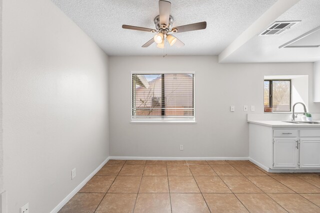 38115 E 41st St, Palmdale, CA 93552 - unfurnished dining area with a sink, a textured ceiling, a ceiling fan, light tile patterned flooring, and baseboards