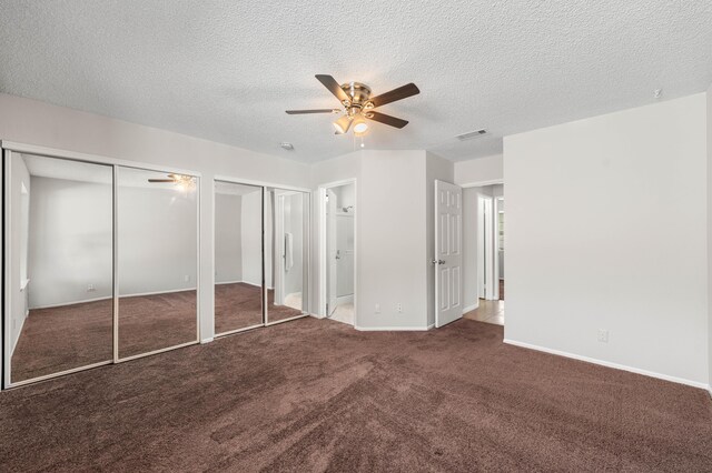 38115 E 41st St, Palmdale, CA 93552 - unfurnished bedroom with two closets, carpet floors, baseboards, a textured ceiling, and a ceiling fan