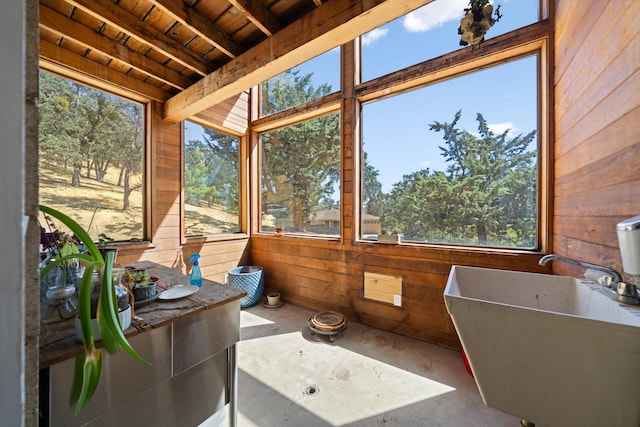 sunroom featuring beamed ceiling, wooden ceiling, and sink