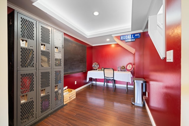 rec room featuring crown molding, a raised ceiling, and dark wood-type flooring