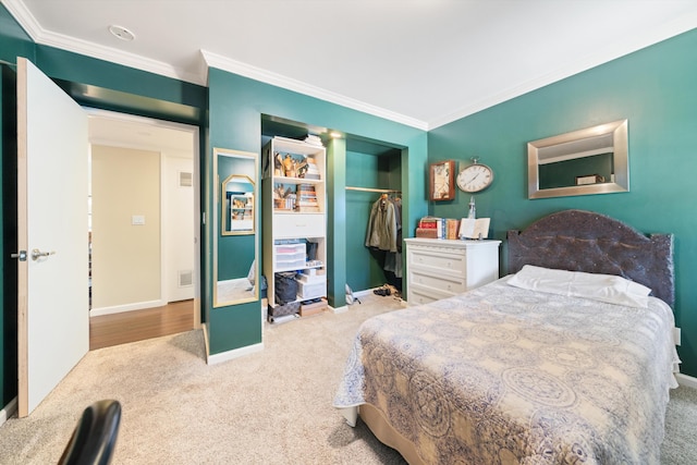 carpeted bedroom featuring a closet and ornamental molding