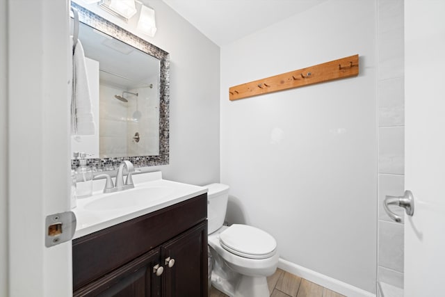 bathroom with vanity, hardwood / wood-style flooring, toilet, and walk in shower