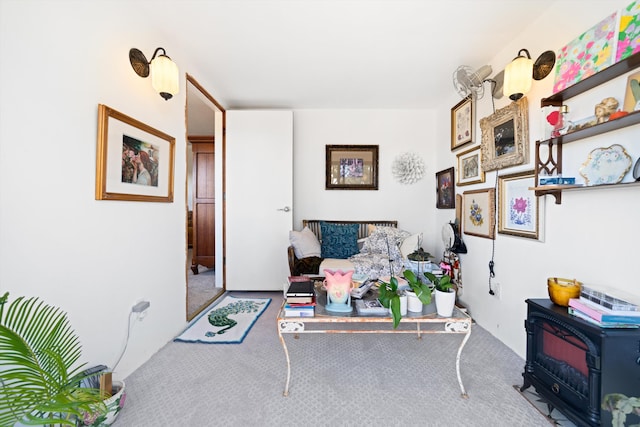 interior space featuring carpet flooring and a wood stove