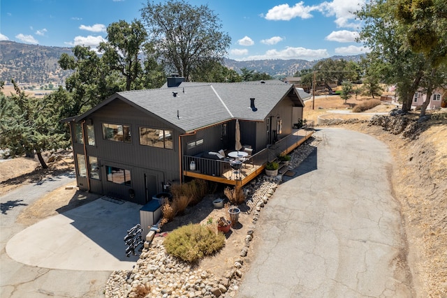 exterior space featuring a deck with mountain view